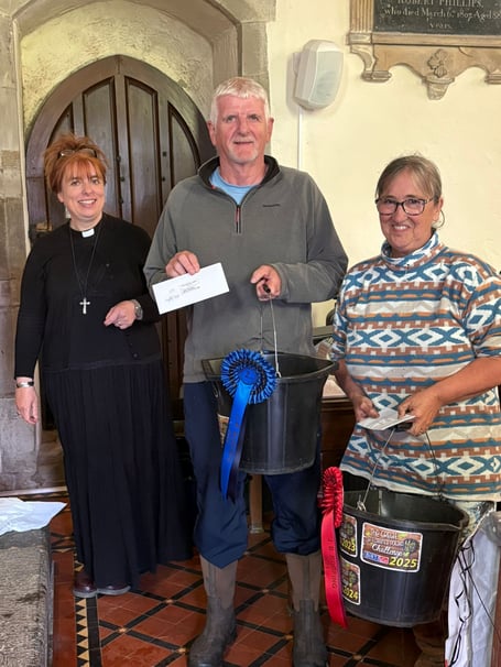 St Florence Church potato challenge - Pictured with Rev’d Martine are Adult Class winners Lawrence Mathias (largest number) and Paula Jeffrey (heaviest crop)