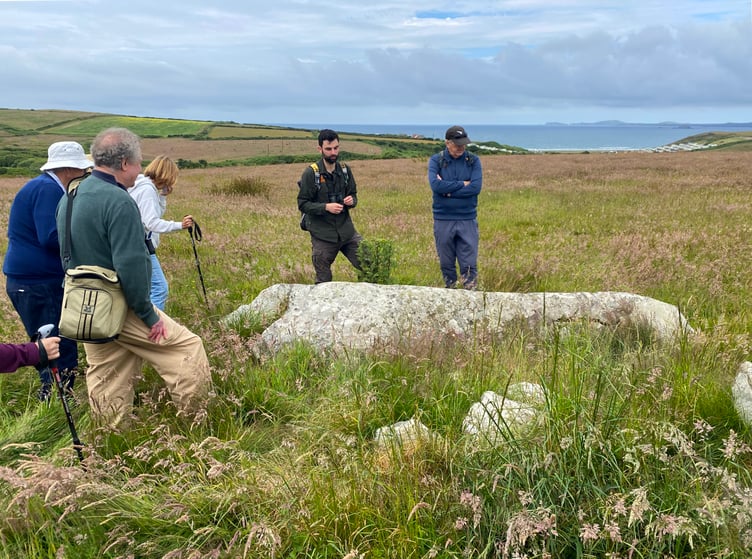 Members of the Pembrokeshire National Trust Association on a walk at Southwood near Newgale, guided by James Roden, Pembrokeshire National Trust Countryside Manager. Glacial erratic
