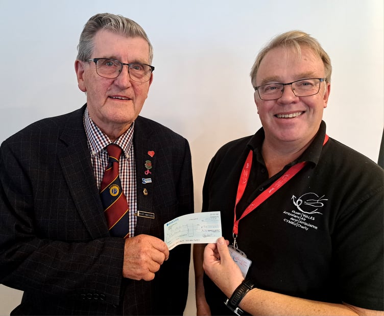 Air Ambulance volunteer and Probus member Rhys Watkins presents Mike May, Wales Air Ambulance, with a donation from the club
