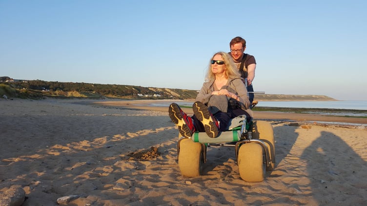 Richard Hutchinson and mum Fiona enjoying a day at the beach using one of the Park Authority’s beach wheelchairs