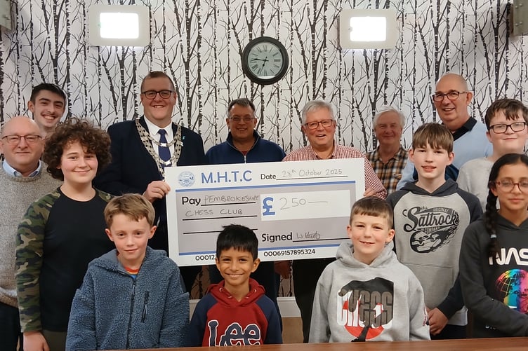 Mayor of Milford Haven, Cllr William Elliott presenting the cheque alongside junior and senior members of Pembrokeshire Chess Club