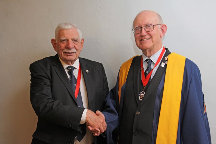 Previous Master Cllr Dennis Evans congratulates the new Master of the Gild of Freemen of Pembroke, Cllr Aden Brinn JP, on his election.