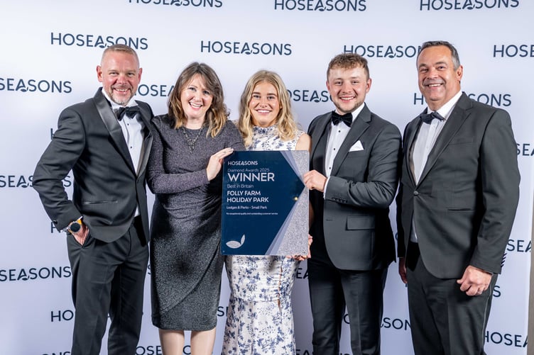 Members of the Folly Farm Holiday Park team - Chris Ebbswoth, Sarah Mattick, Zoe Wright and Jamie Ebsworth - receive their award from Neil Davies, Director of Commercial and Business Development – Hoseasons (pictured far right).