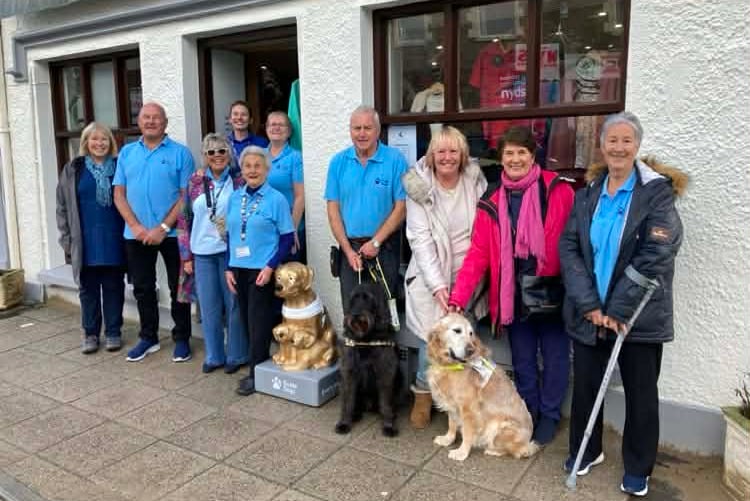 Volunteers from Guide Dogs Pembrokeshire at the unveiling of the gold-coloured collecting box