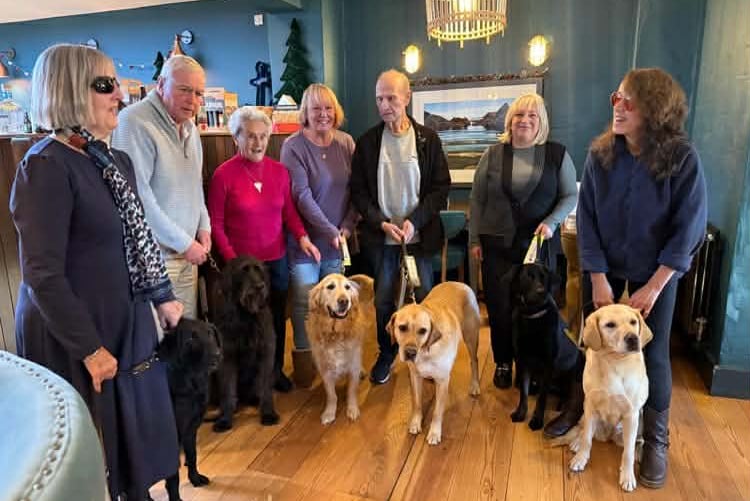 Pictured at the Guide Dogs Pembrokeshire 50th anniversary lunch at the Harbwr Bar are (l-r) Annette Peter, Adge John, John Woolsgrove, Sue Canham, Karol Milton and Malika Rankin with guide dogs Beulah, Skip, Eddy, Henry, Gemini and Zoe.