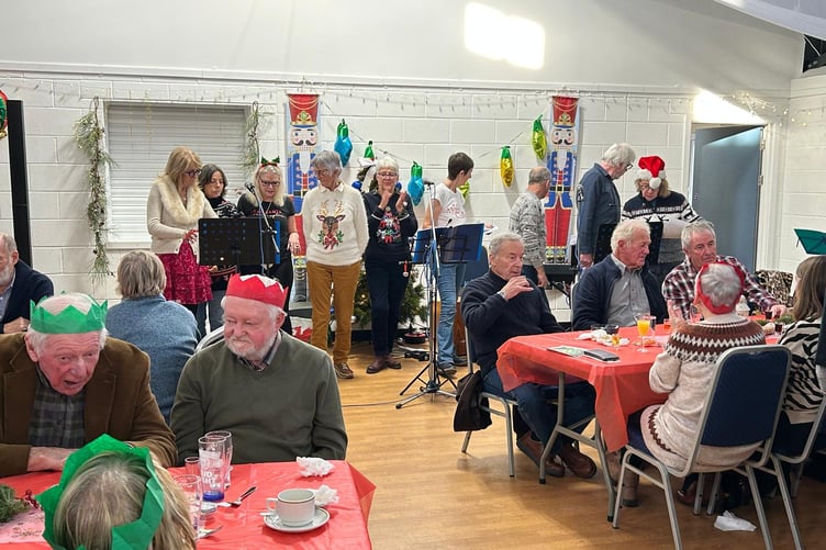 Cockles & Mussels choir at Manorbier Community Christmas Lunch, Giraldus Centre, December 2025