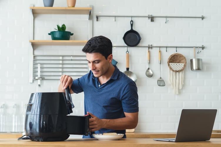 man using air fryer