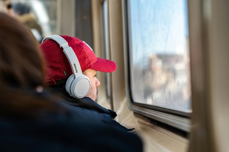 Man wearing headphones on train