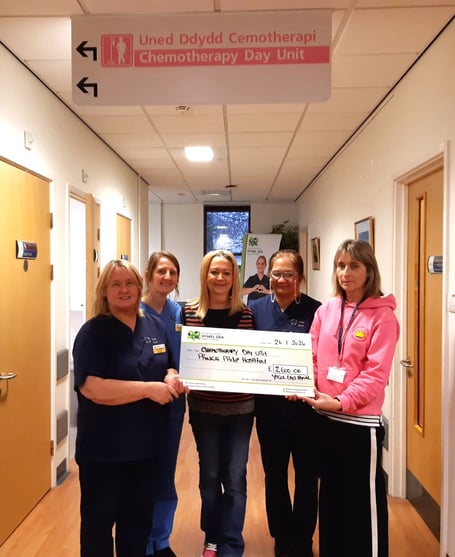 Caroline Thomas (centre) and Vanessa Roberts (far right) with staff from the chemotherapy day unit at Prince Phillip Hospital