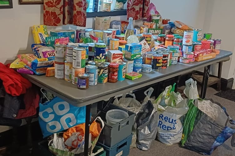 Fourth Food Bank Run: The donations table was so full that bags had to be stashed underneath!