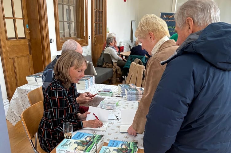 Mary Powles signing novels