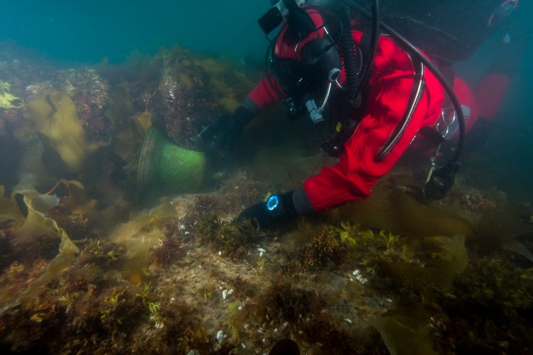 Windlass and bell in situ, Filippo Ronca shinning light on bell. Broad arrow visible.