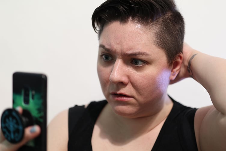 woman looking shocked at phone