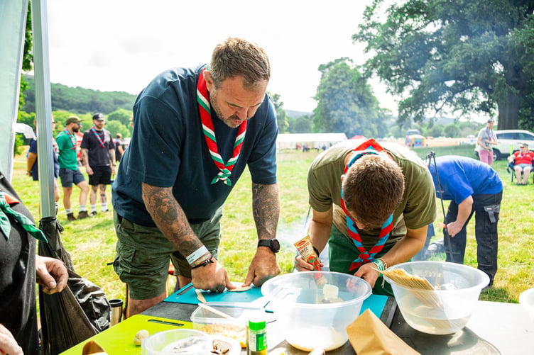 ScoutsCymru Vice President Scott Quinnell levelling up his cooking skills at Explorer camp
